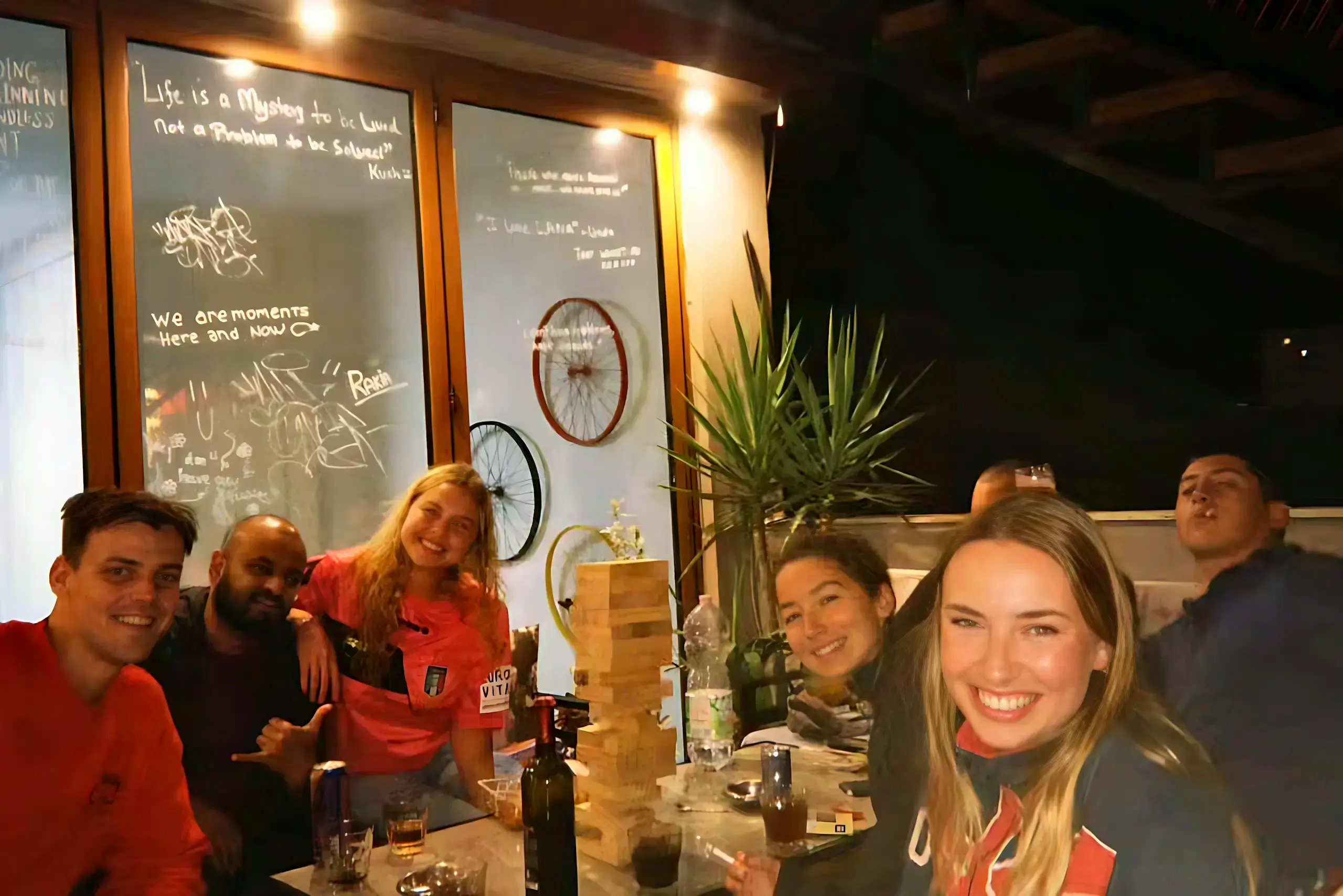 Guests enjoying games on the outdoor patio at Scodrinon Hostel